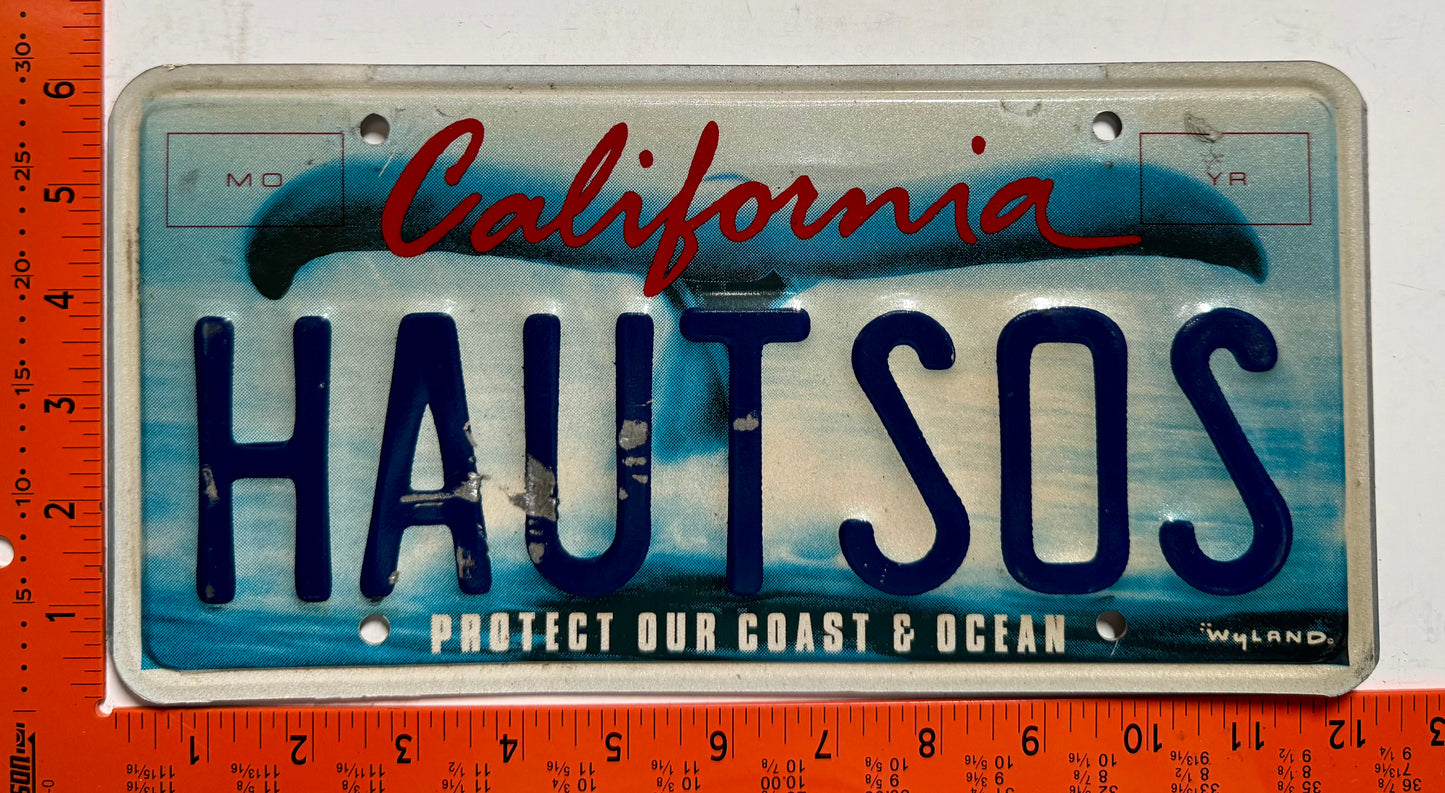 undated California #HAUT SOS Passenger Vanity Whale Tail License Plate